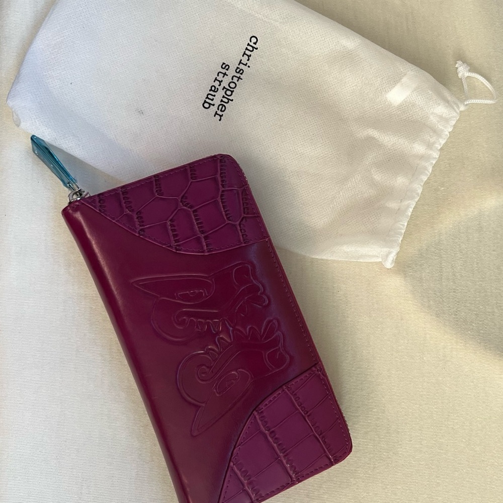 $10 plus $4.99 shipping 
Orchid Ladies Leather Clutch by Christopher Straub